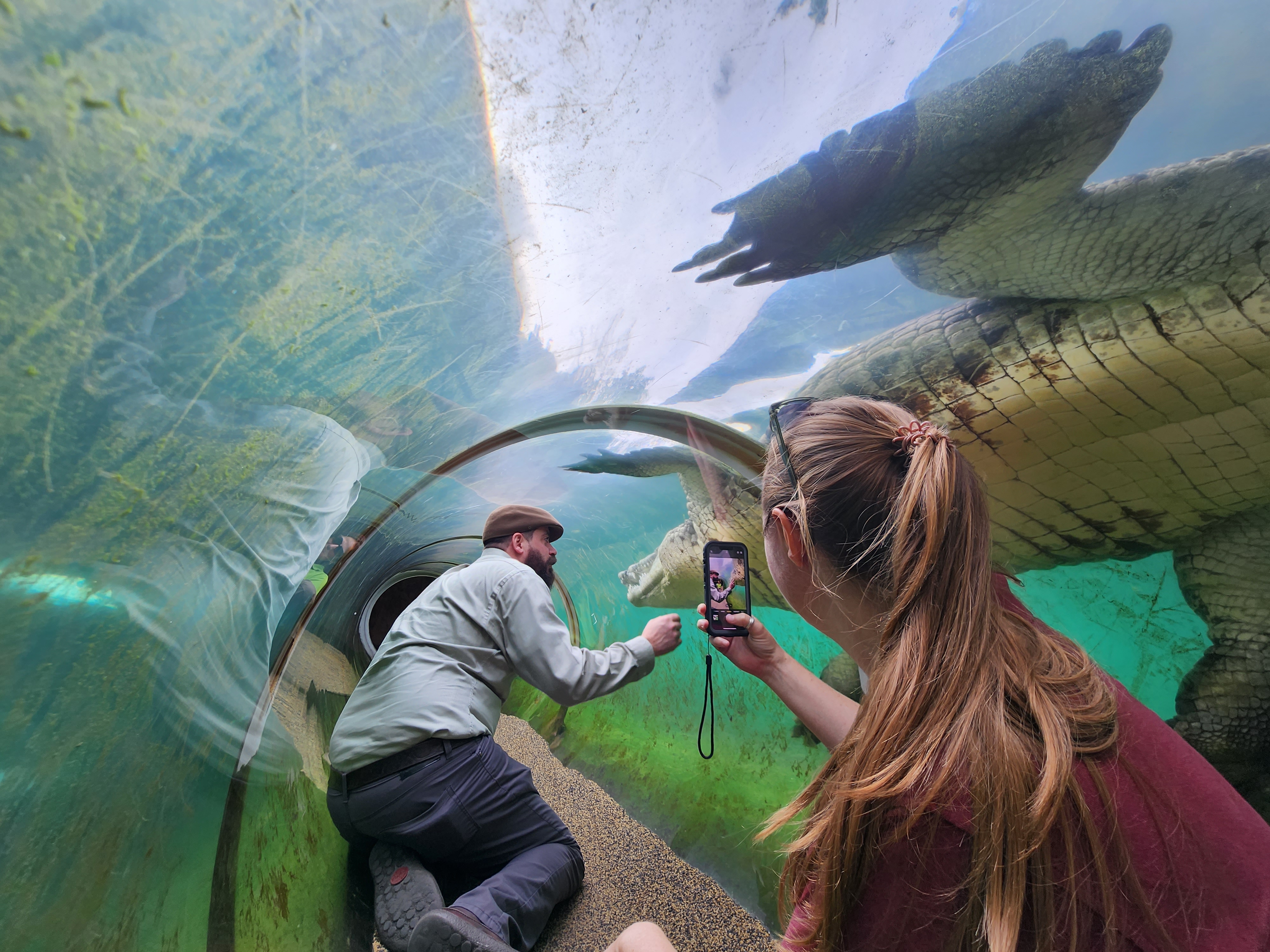 Earth to Sky participants observing an alligator exhibit